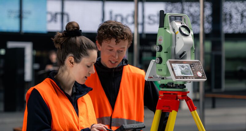 Survey professionals using a custom‑made application to control and capture data from a Leica TS20 robotic total station, demonstrating software integration with Leica Geosystems surveying instruments.